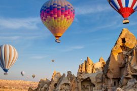 Hot air balloons flying over fairy chimneys in Cappadocia